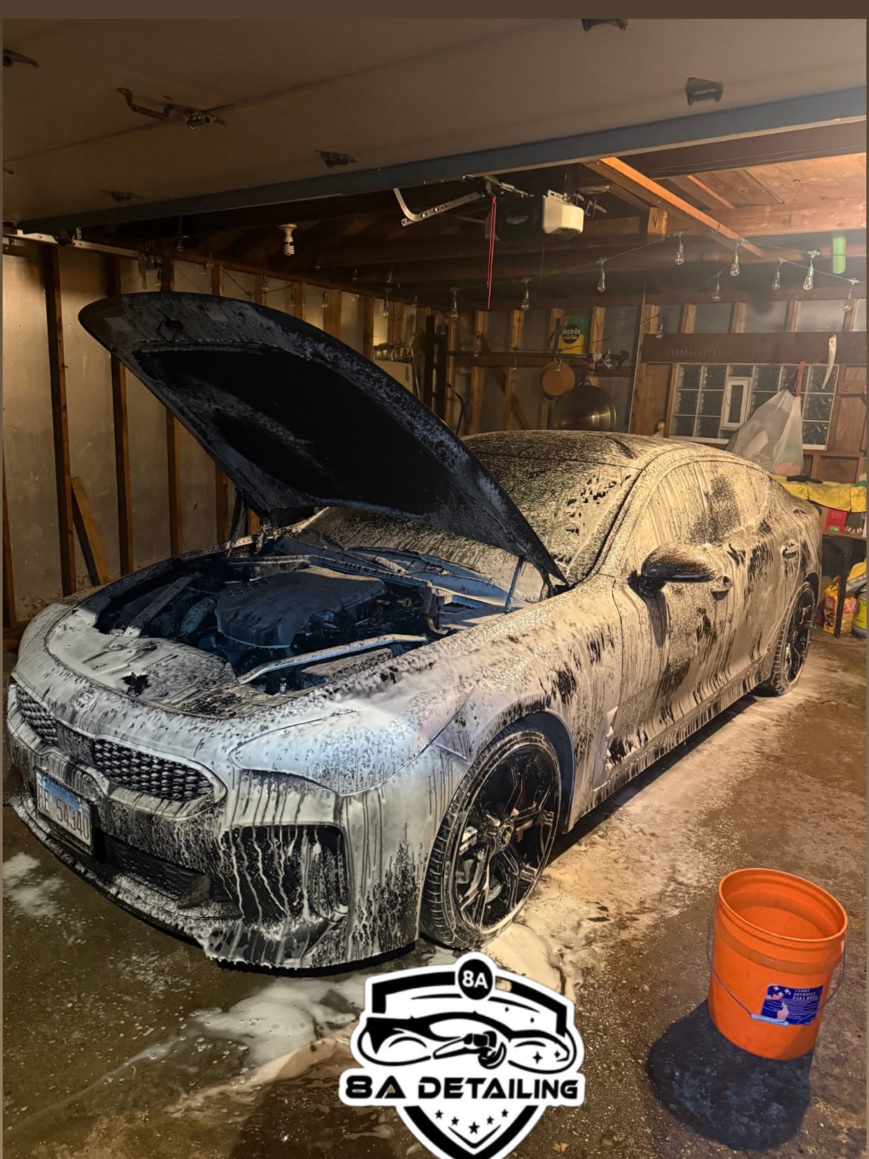Kia Stinger covered in foam during a garage wash